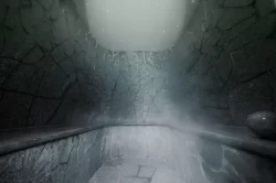Steam room with natural stone walls and mist in the wellness area of Hotel Bellerive Zermatt.