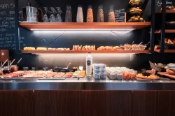 Breakfast buffet with cold cuts, salmon, yoghurt jars and pastry shelves at Hotel Bellerive Zermatt